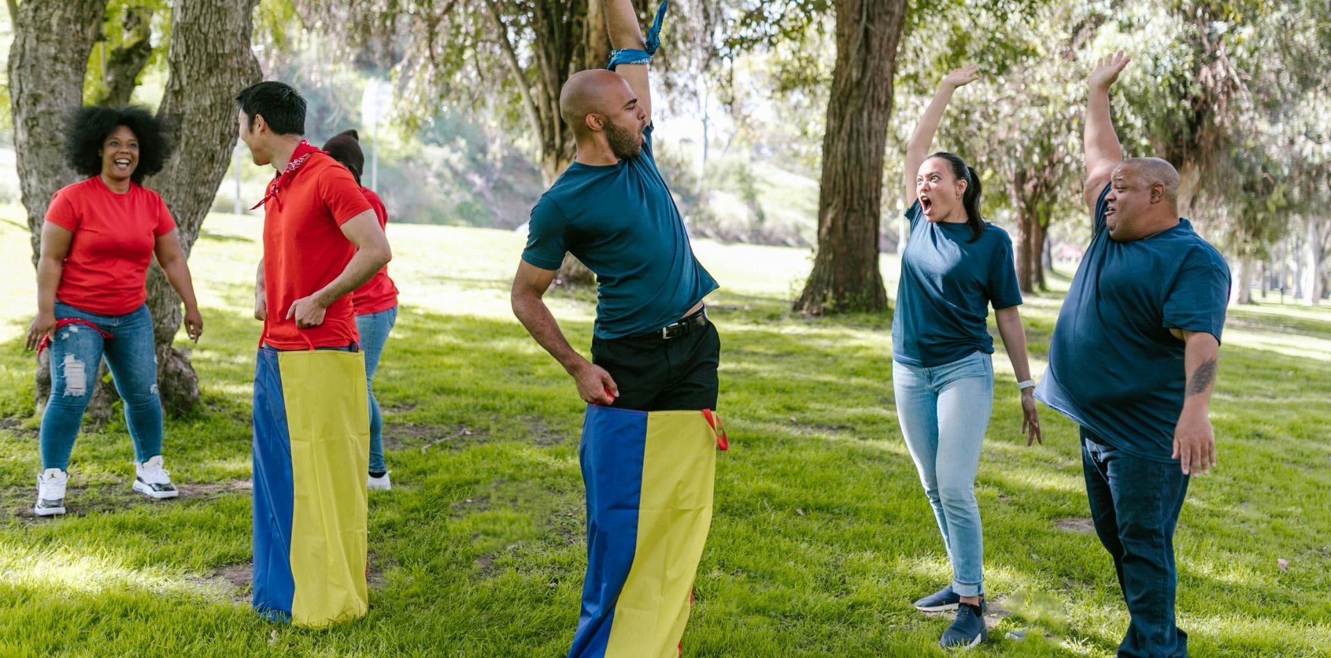 A group of people standing in the grass.