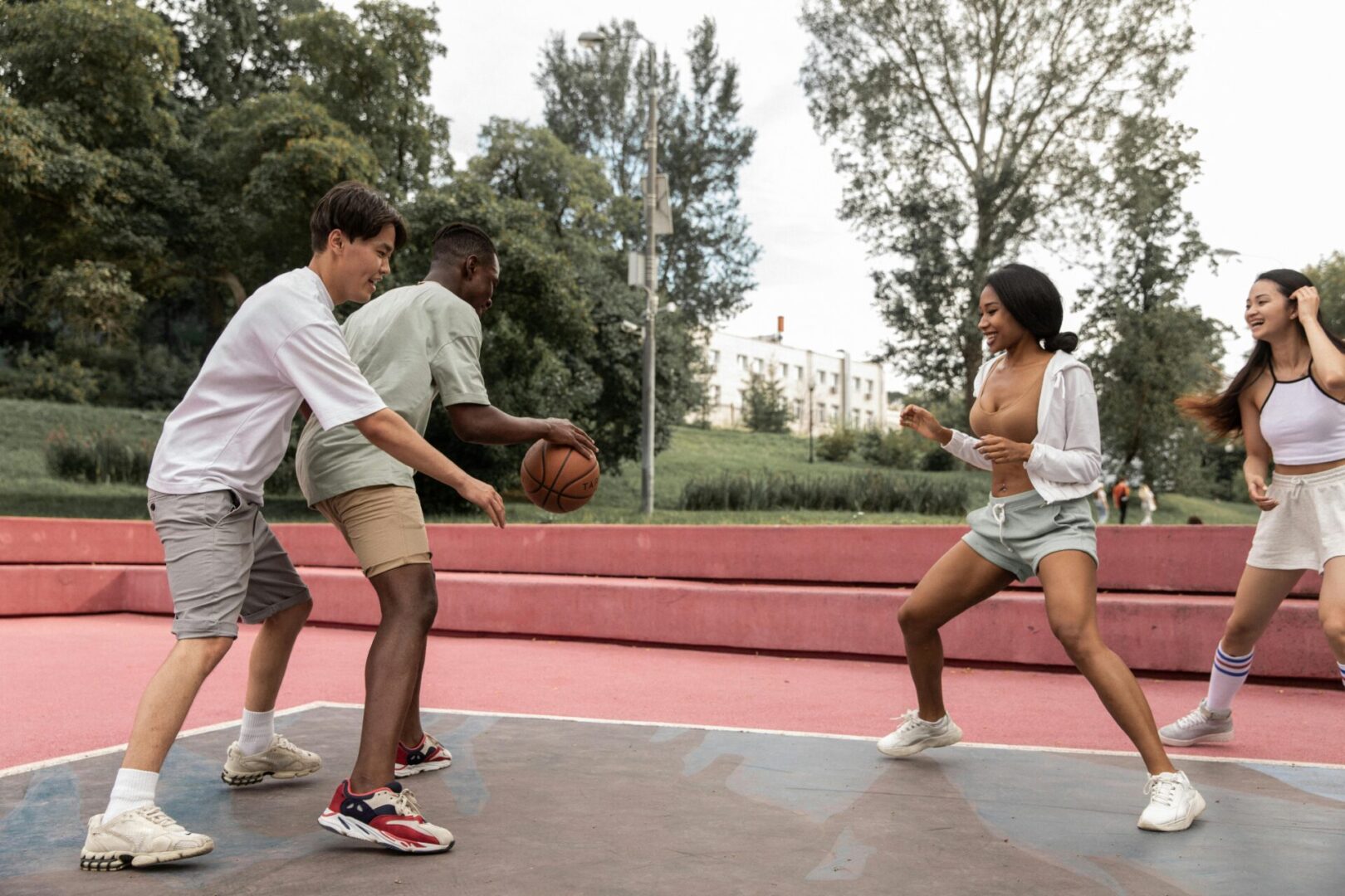 Three young men playing basketball on a court.